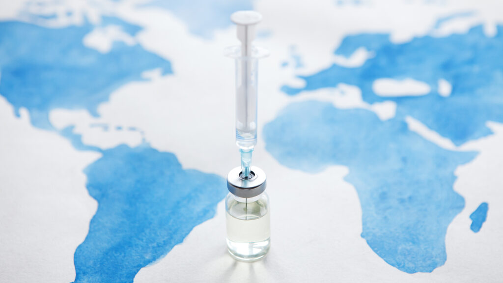 Healthcare worker administering vaccine to young child in developing country clinic setting