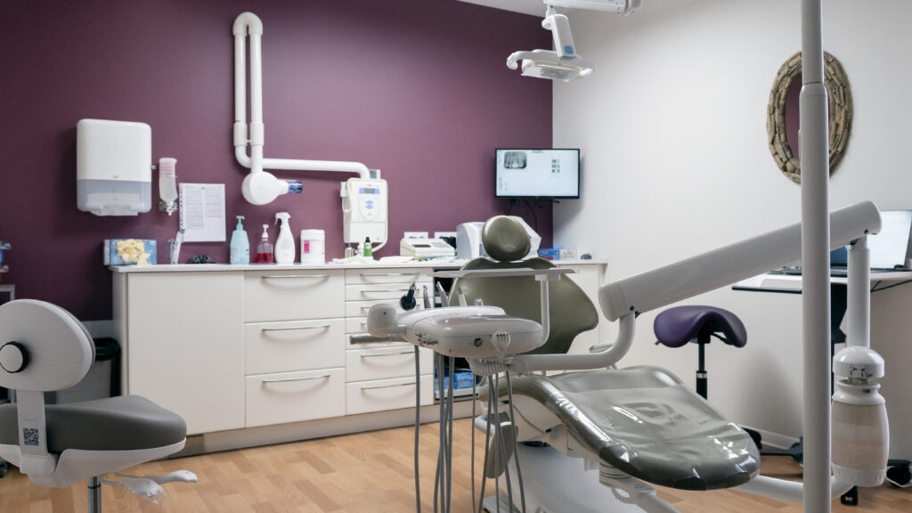 Dentist having compassionate conversation with patient in modern dental examination room