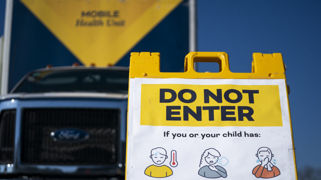 Mobile health clinic with vaccination warning sign in Spartanburg, South Carolina during measles outbreak