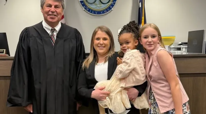 Deputy Britanie Bratcher hugging her newly adopted daughter after finalization ceremony in Greenville County