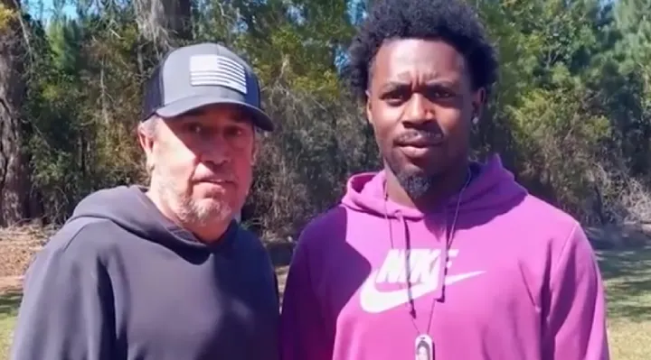 Two men pose with elderly truck crash survivor Steve Howell after heroic rescue