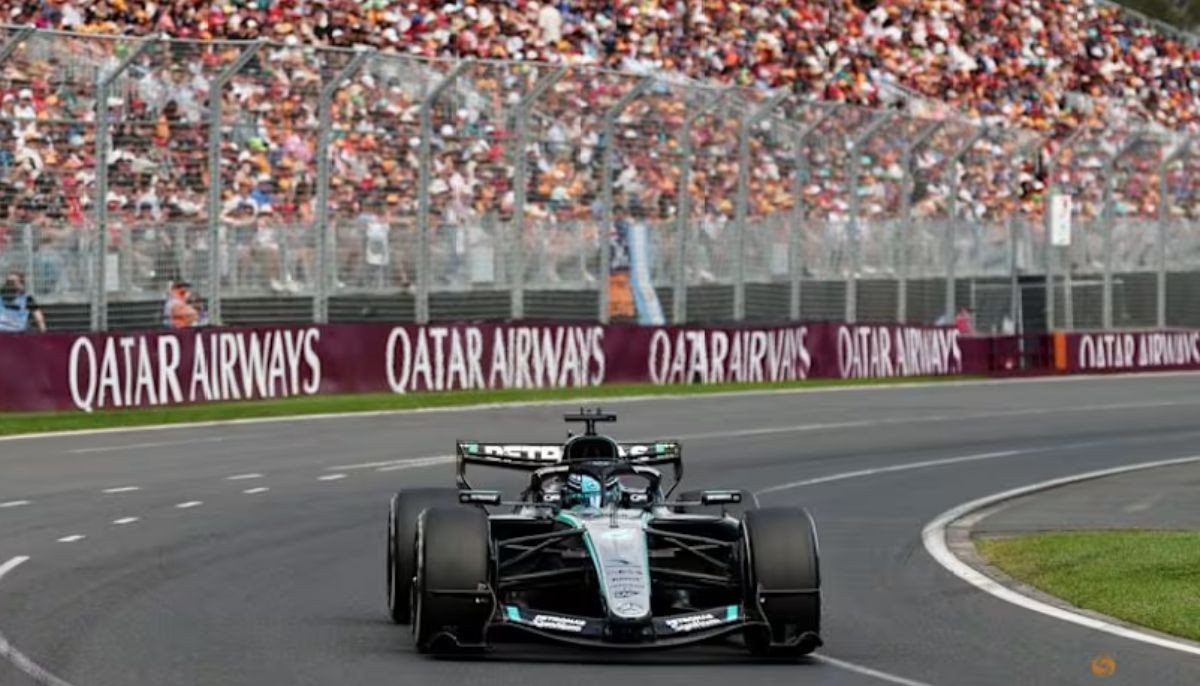 George Russell celebrates on podium after winning Australian Grand Prix in Mercedes