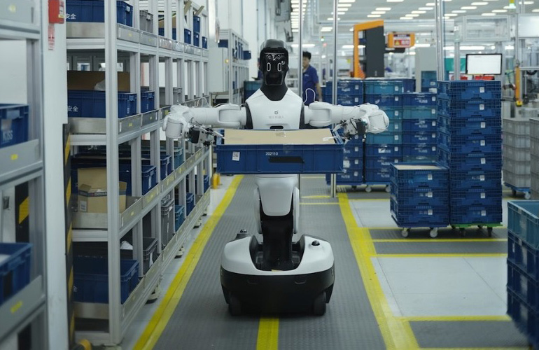Humanoid robot with articulated arms and wheeled base collecting data in real-world environment