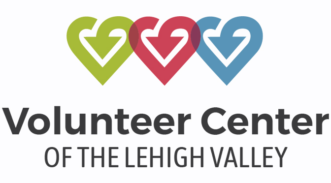 Diverse group of volunteers serving warm meals and helping community members at local shelter