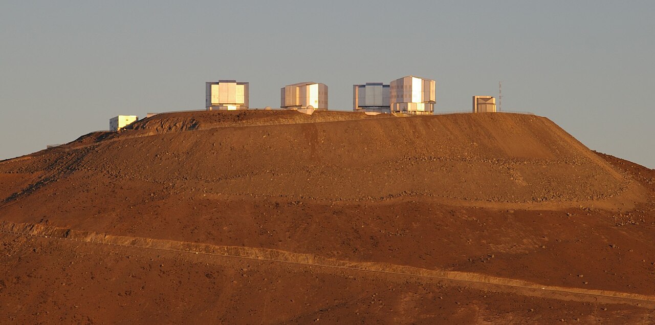 Very Large Telescope array at Paranal Observatory under star-filled night sky in Chile's Atacama Desert