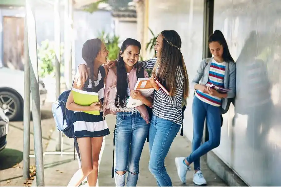 Diverse group of teenagers laughing together and sharing genuine moment of connection