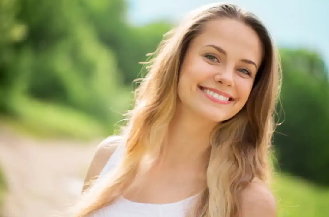 Woman looking thoughtfully at camera, representing journey through weight changes and personal growth