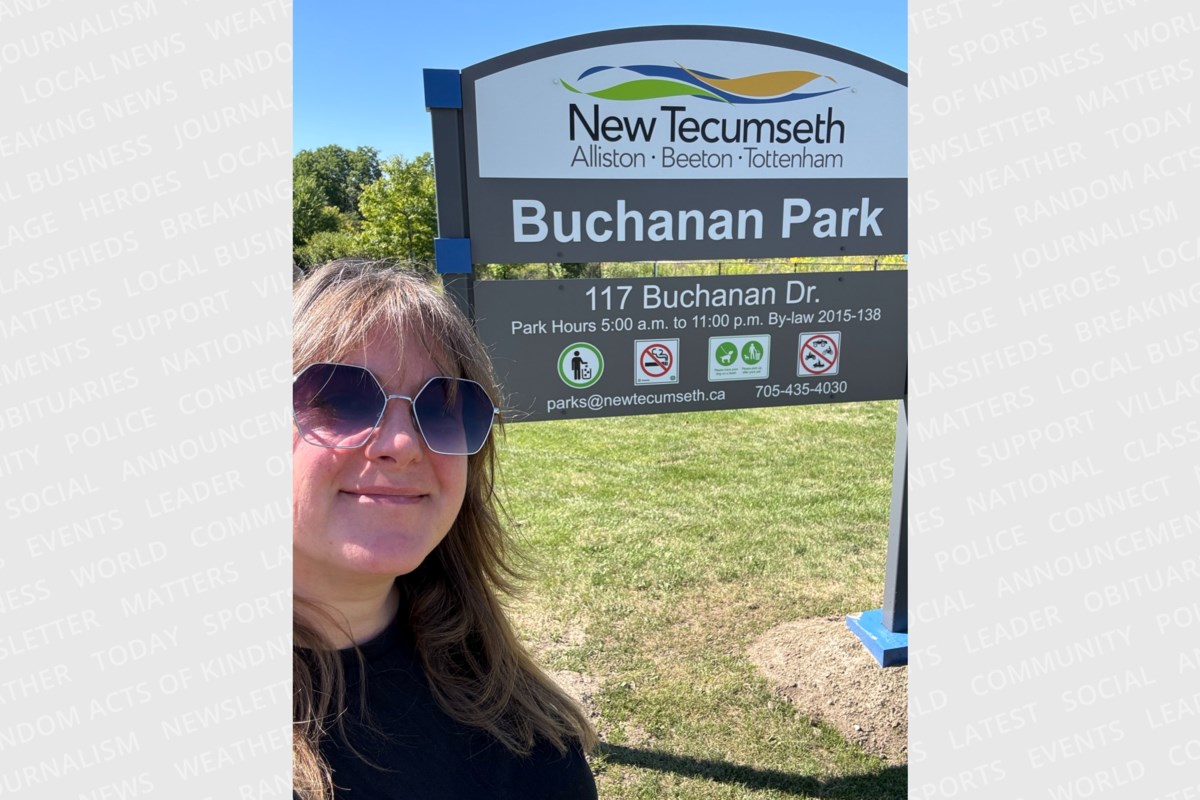 Woman standing in Canadian park smiling after completing her 225-park cross-country journey
