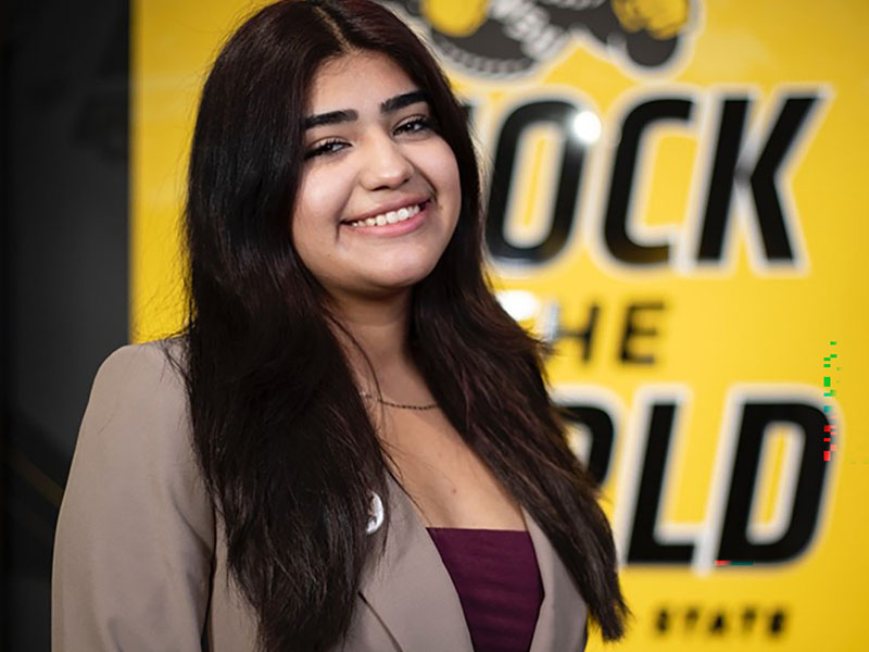 Smiling high school senior Dulce Torres Gonzalez celebrating her scholarship achievement at Wichita State University