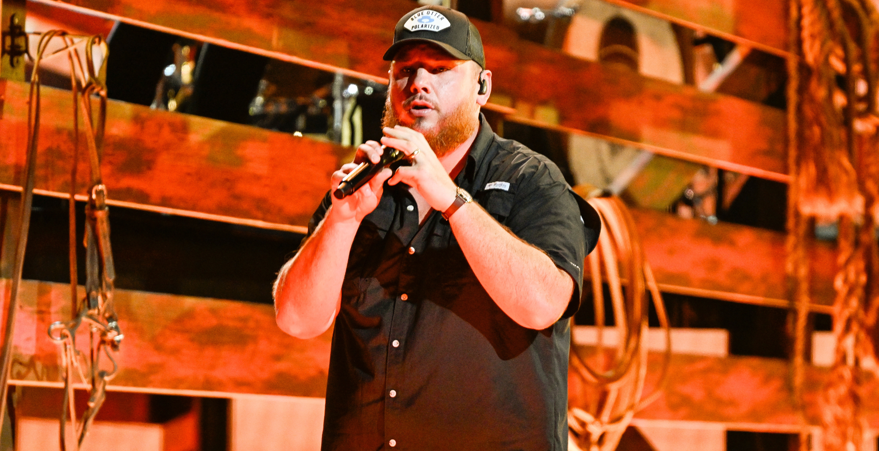 Luke Combs holding sports cards during his Packs with Purpose charity live stream event