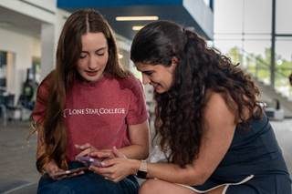Student using laptop to access Ellis C. chatbot for college advising support at Lone Star College
