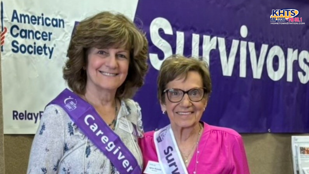 Cancer survivors and caregivers celebrating together at community dinner event with food and decorations