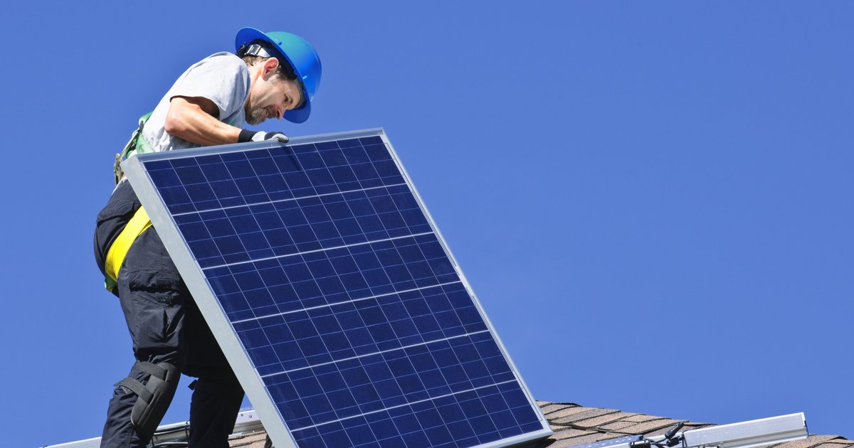 Solar panels on British residential rooftops gleaming under bright summer sunshine producing clean energy