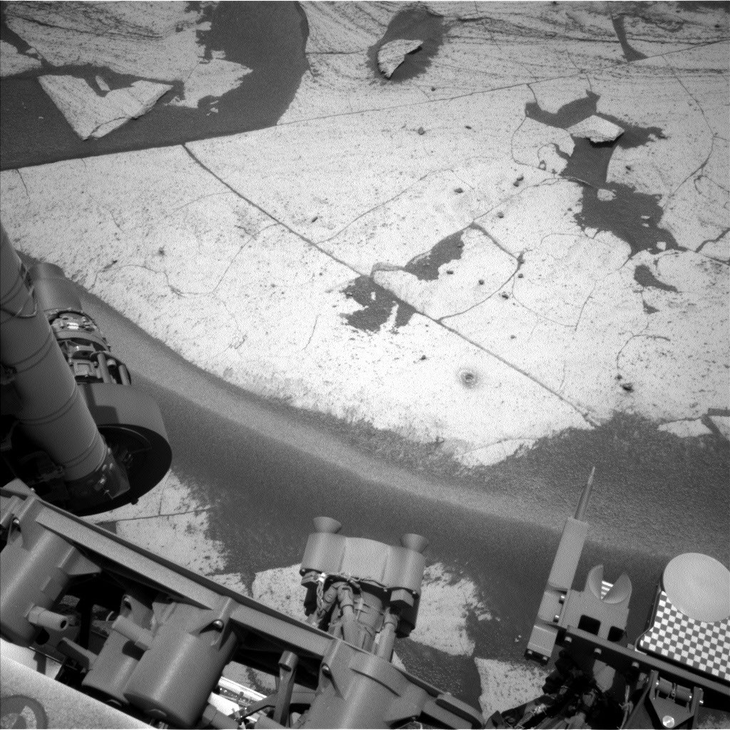 Curiosity rover's drill hole and rock tailings on Martian surface at Basque Lakes site