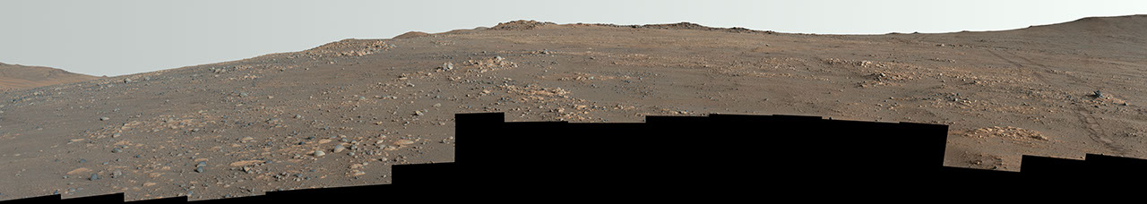 Sweeping enhanced-color panorama of windswept Martian landscape showing diverse rocky terrain at Arbot location