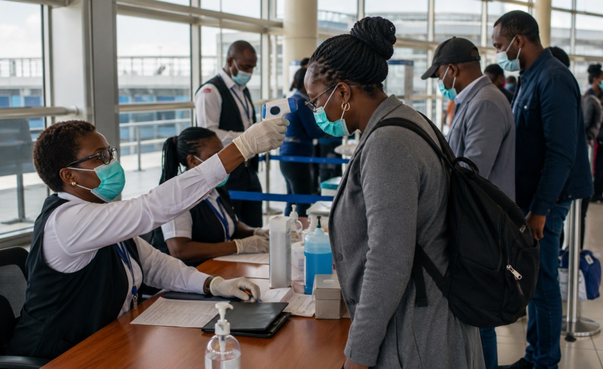 Health screening checkpoint at Kenya border crossing with medical staff assisting travelers
