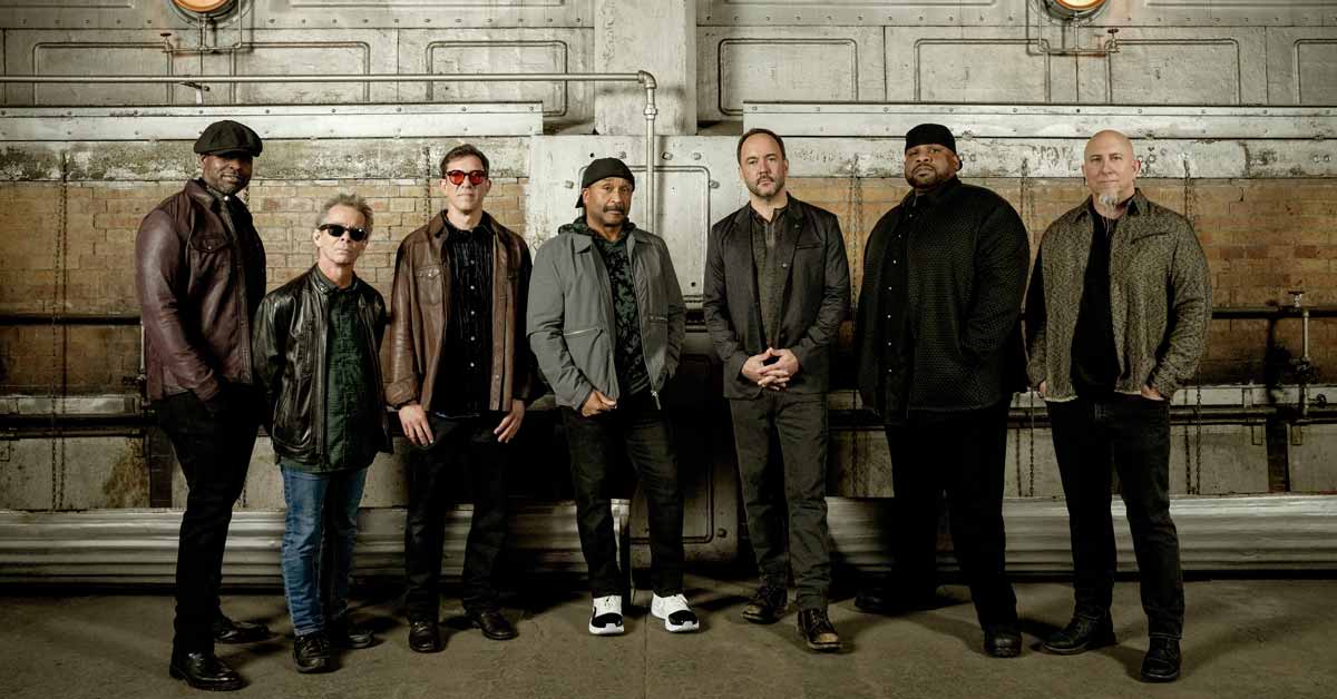 Dave Matthews performing on stage with guitar during concert at outdoor amphitheater venue