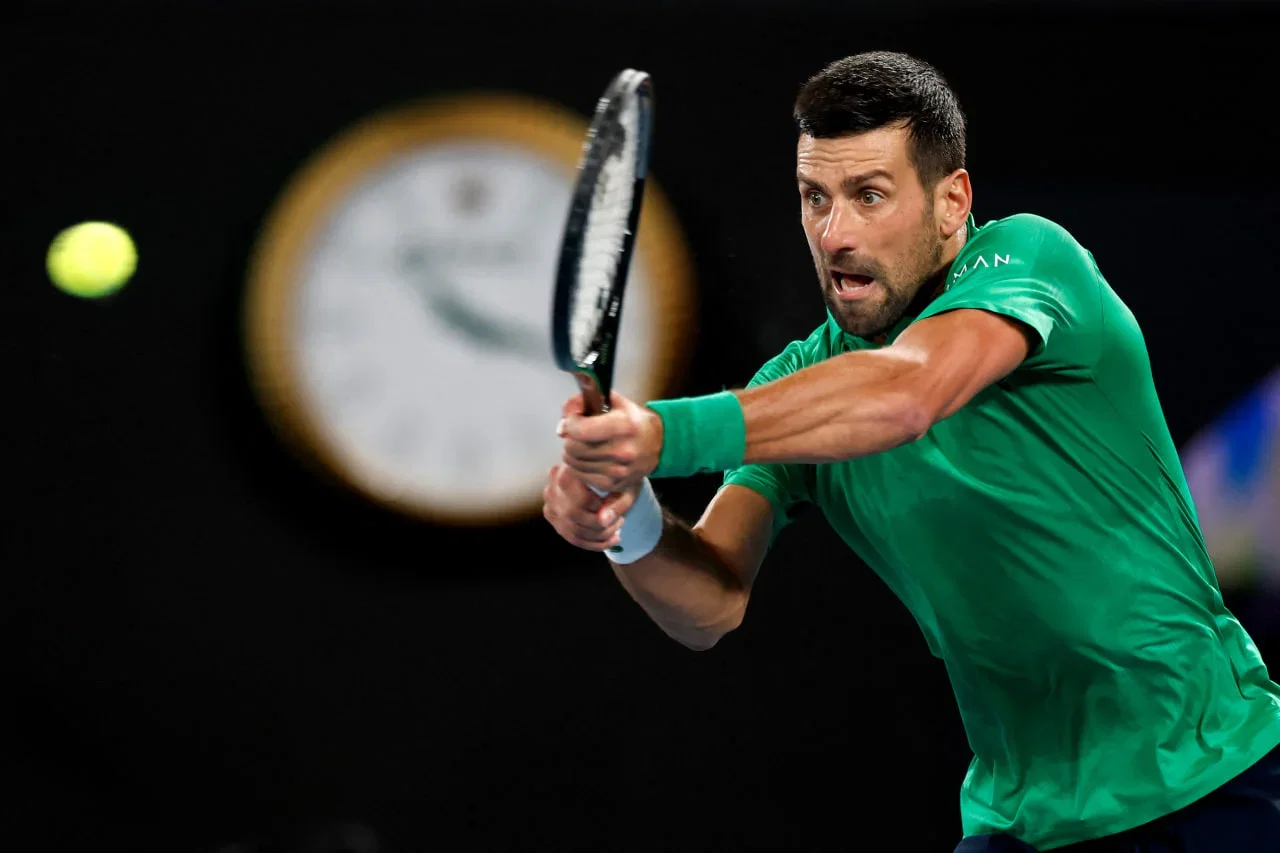 Novak Djokovic celebrating on court at Australian Open after historic 100th tournament victory