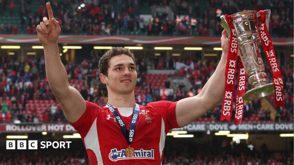 George North in red Wales rugby jersey carrying the ball during an international match