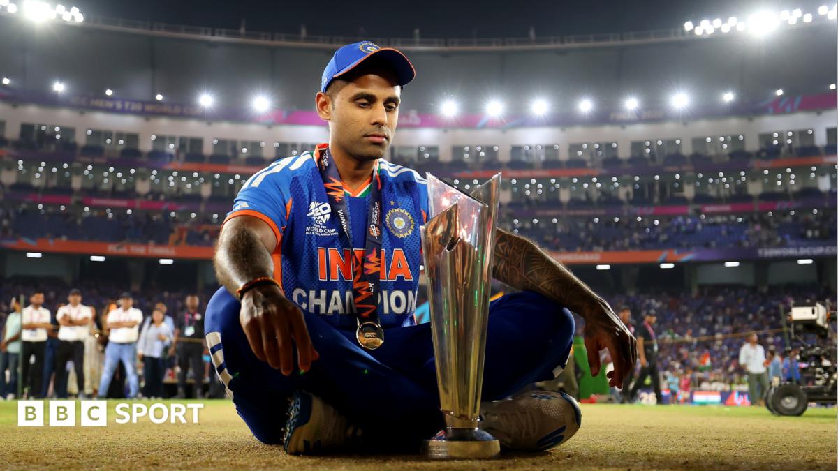 Indian cricket team celebrates together holding T20 World Cup trophy in packed stadium