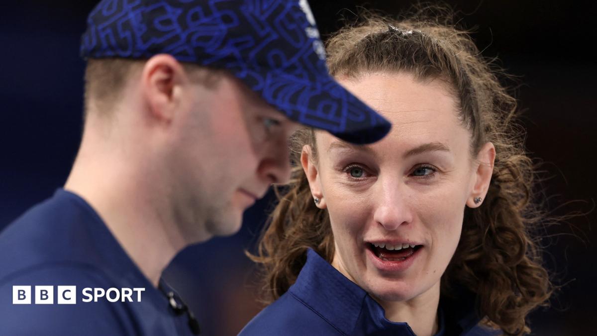 British curlers Bruce Mouat and Jen Dodds celebrating on ice at Winter Olympics
