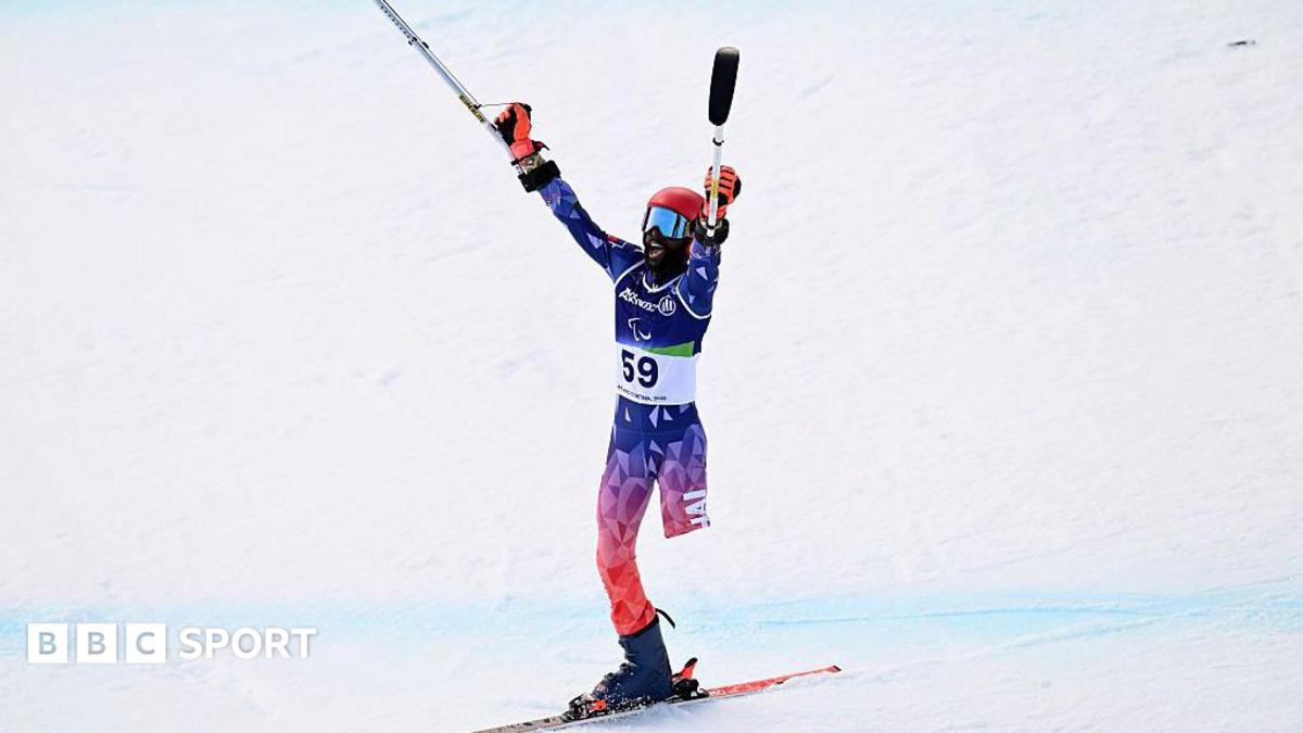 Ralf Etienne celebrates at Winter Paralympics wearing Haiti's red and blue colors