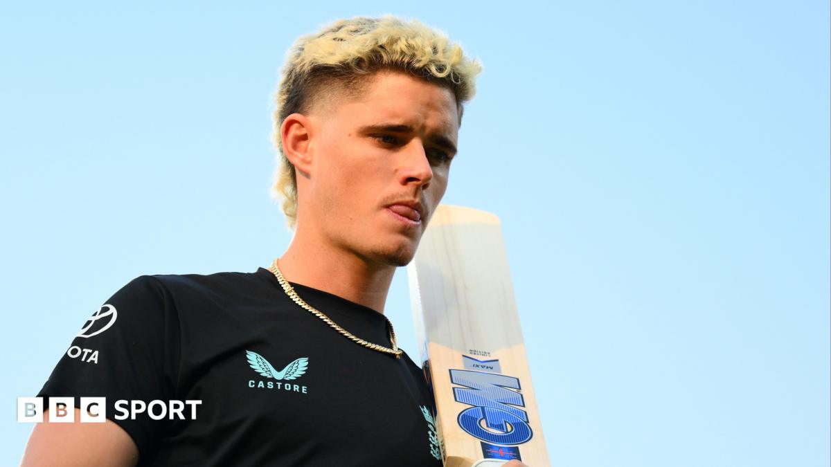 Young cricketer Jacob Bethell in white cricket gear celebrating his century achievement