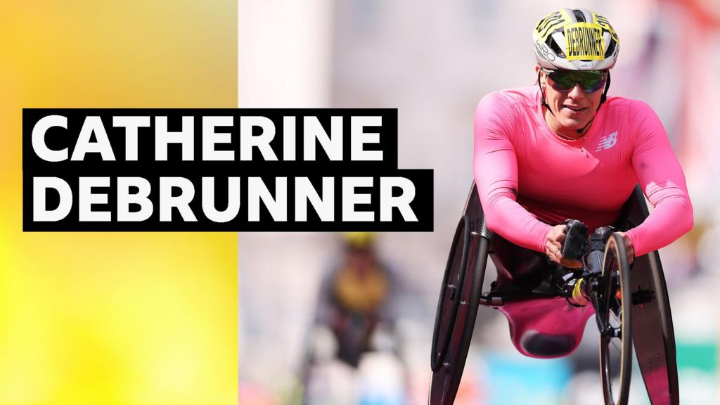 Catherine Debrunner racing in wheelchair at London Marathon crossing finish line ahead of competitors