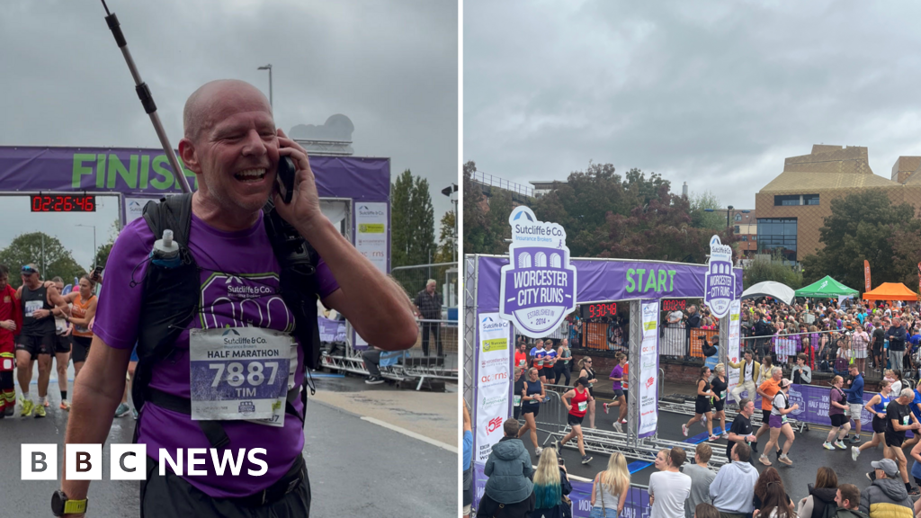 Radio producer Tim Boswell running half marathon while wearing broadcasting equipment and large flag