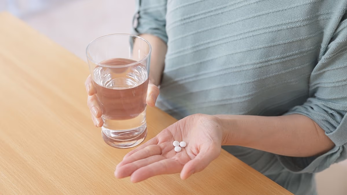 Researcher examining oral medication pills in modern pharmaceutical laboratory setting