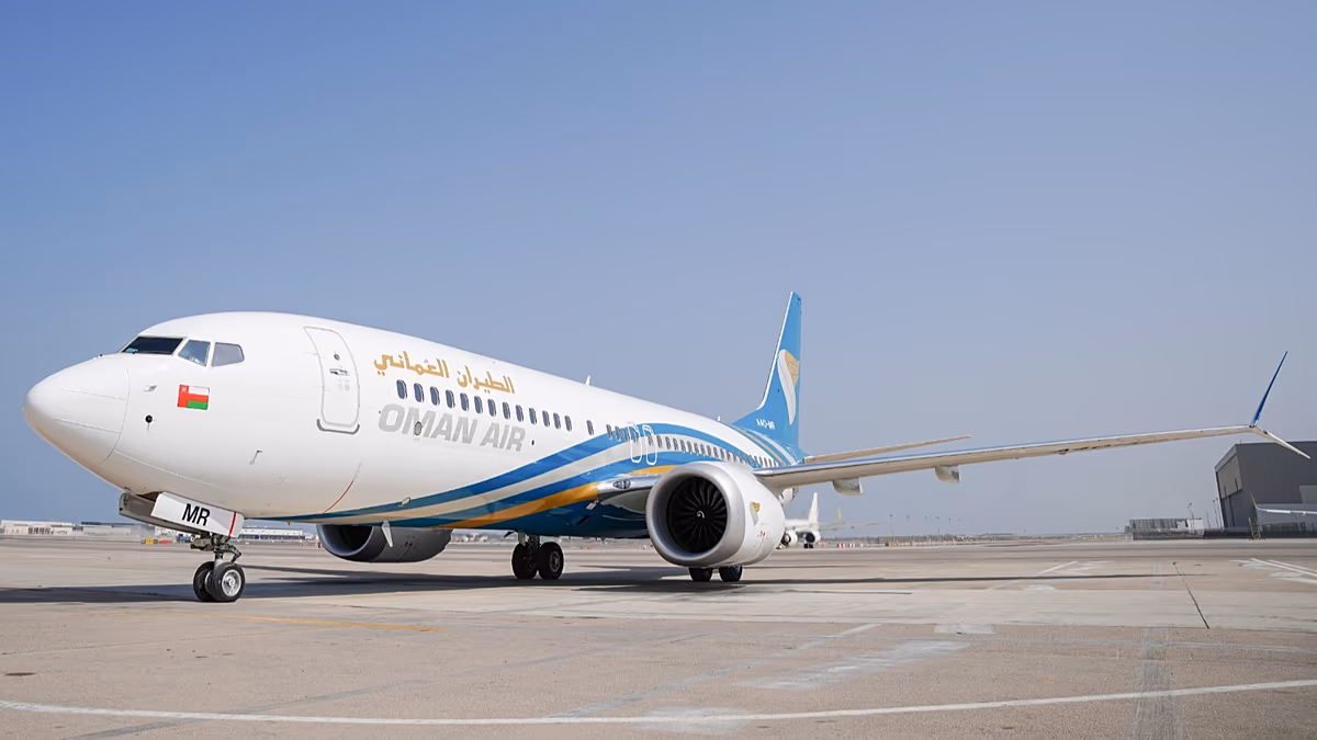 Oman Air aircraft at Muscat International Airport preparing for passenger boarding operations