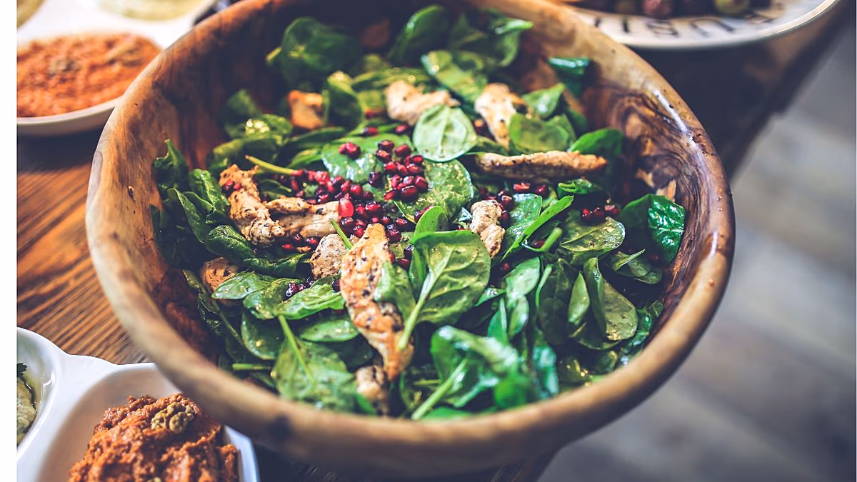 Colorful array of fresh vegetables, fruits, whole grains, and nuts representing healthy plant-based foods