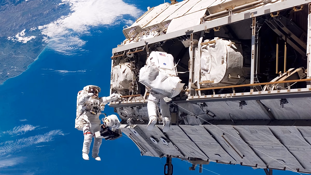 Astronaut conducting grip force experiment aboard International Space Station in microgravity environment