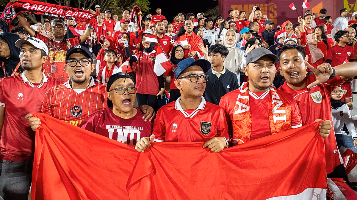 Young football fans cheering enthusiastically during U-17 World Cup match in Doha, Qatar