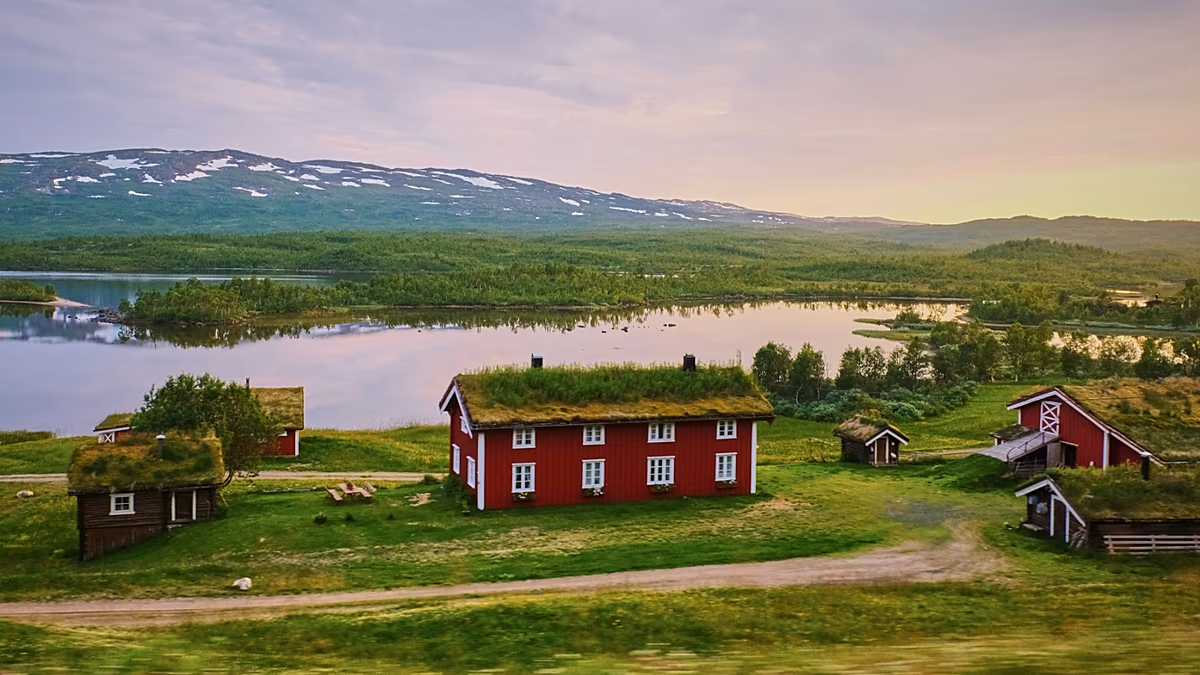 Swedish sauna overlooking serene lake surrounded by forest at sunset