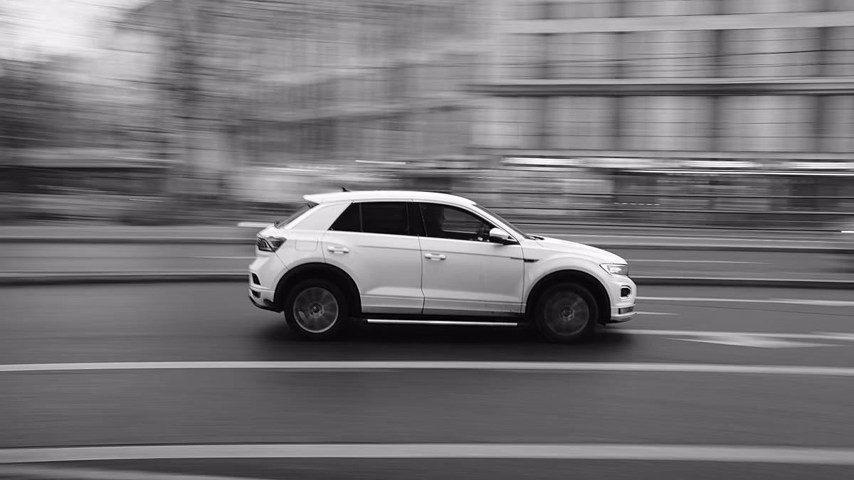 Modern autonomous vehicle driving through urban Munich streets with historic architecture in background