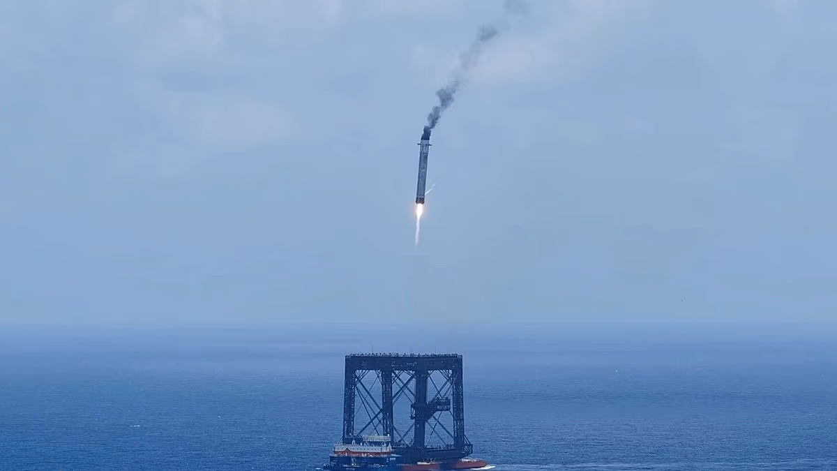 Long March-10B rocket booster descending toward floating ocean platform during historic controlled landing