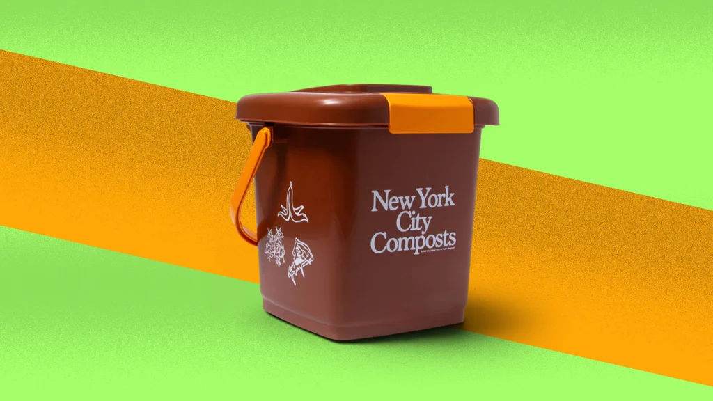 Brown tabletop compost bin with orange clasp and NYC Sanitation graphics on kitchen counter