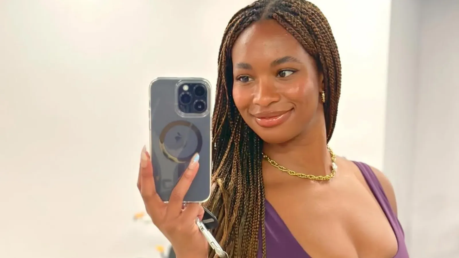 Young woman smiling while recording content on camera for social media platform
