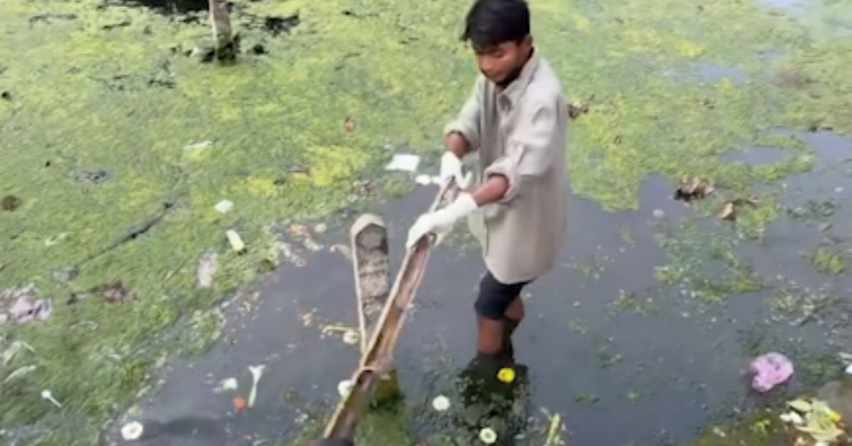 Young man Bittu Tabahi cleaning waste from polluted riverbank in Madhya Pradesh India