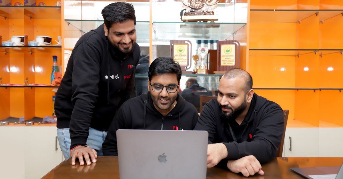 Three male founders of STAGE streaming platform standing together smiling at camera