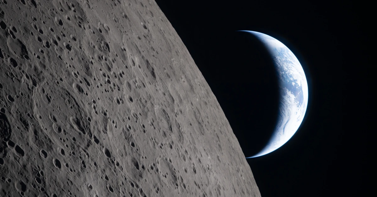 Stunning view of moon's cratered surface with Earth visible in distant space background