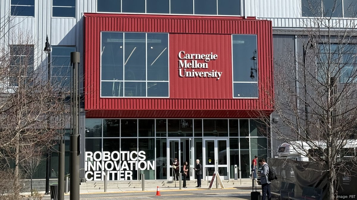 Modern robotics laboratory with collaborative robots working alongside human researchers at innovation center