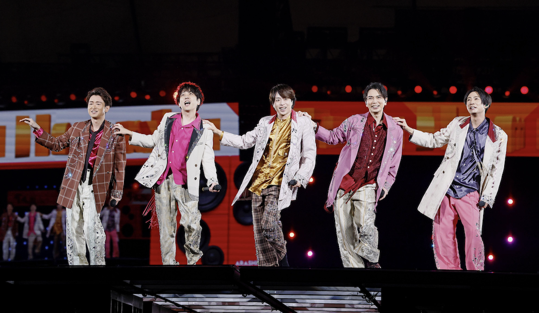 Five members of Japanese boy band Arashi performing on stage at Tokyo Dome