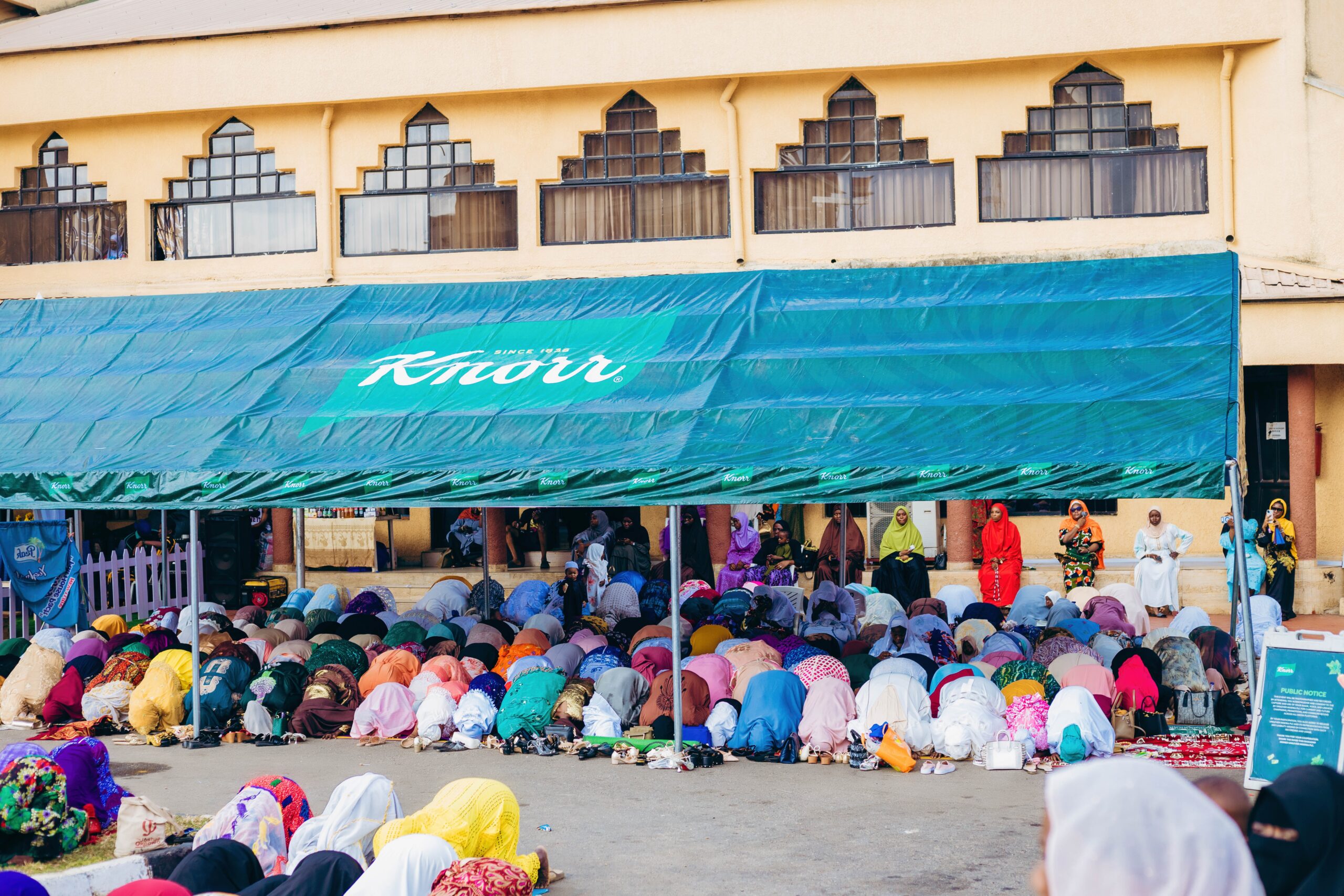 People gathering around food distribution during Ramadan Iftar meal sharing in Nigeria