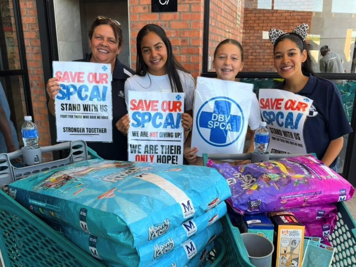 Young volunteers with Paw Patrol characters at animal shelter fundraising event in South African mall