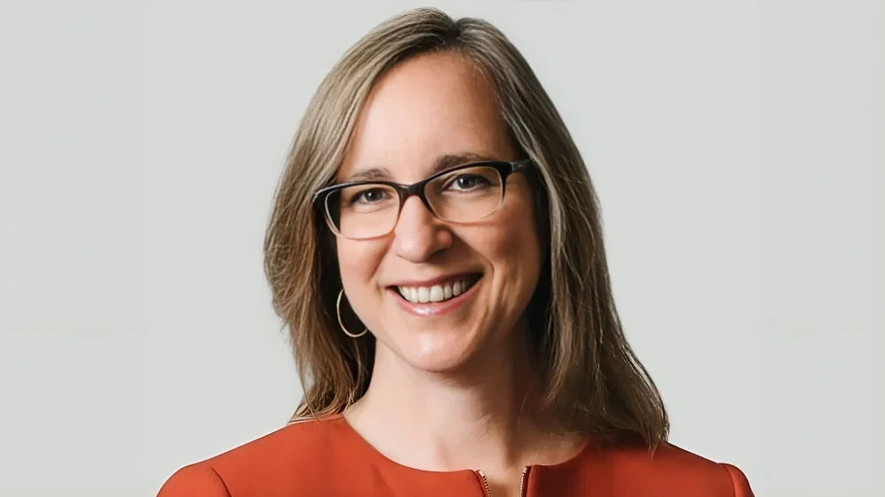 Medical research scientist examining cancer treatment data in modern laboratory setting