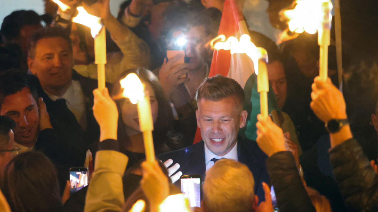 Peter Magyar celebrates with supporters along Budapest's Danube River after winning Hungary's parliamentary election