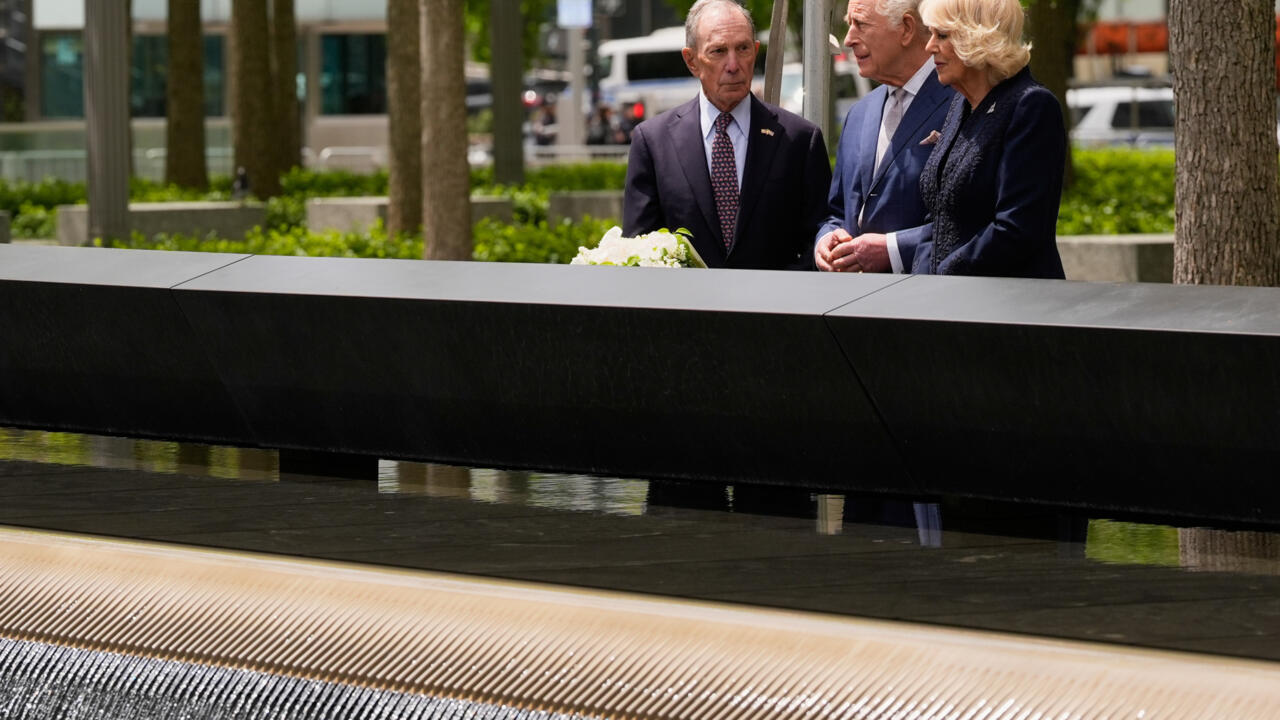 King Charles III and Queen Camilla laying white roses at the 9/11 Memorial reflecting pools