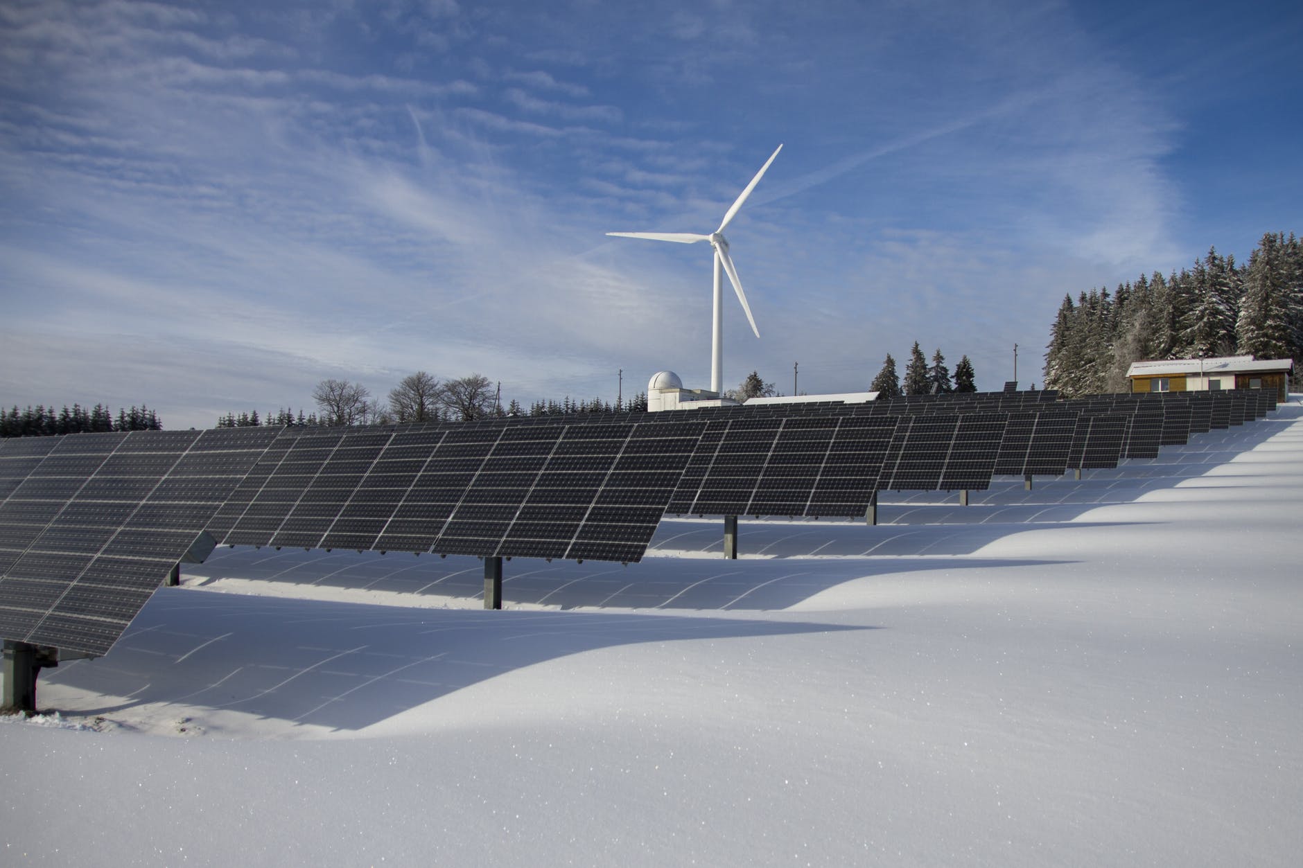 Wind turbines and solar panels generating renewable electricity across German countryside landscape